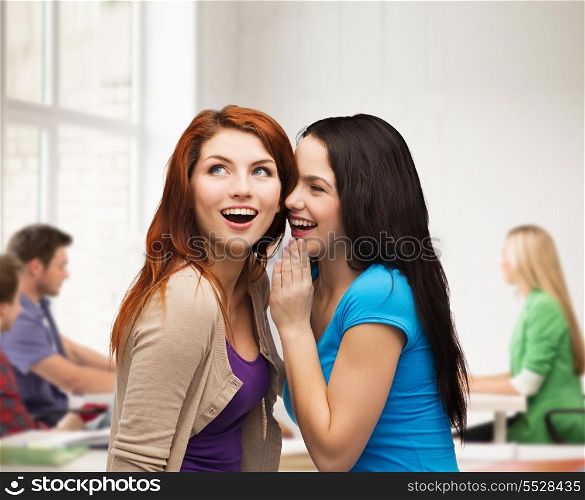 friendship, happiness and education concept - two smiling girls whispering gossip