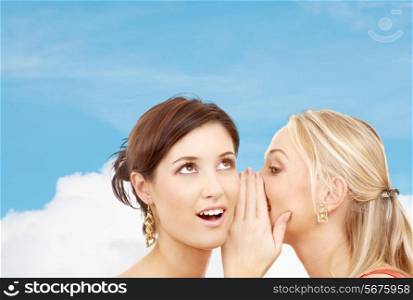 friendship, happiness and people concept - two smiling women whispering gossip