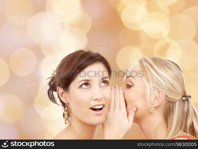 friendship, happiness and people concept - two smiling young women whispering gossip