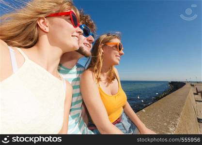 Friendship happiness summer holidays concept. Group of friends boy two girls in sunglasses having fun outdoor, joy playful mood.. Group friends boy two girls having fun outdoor