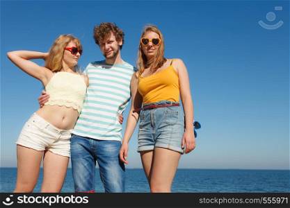 Friendship happiness summer holidays concept. Group of friends boy two girls in sunglasses having fun outdoor, joy playful mood.. Group friends boy two girls having fun outdoor
