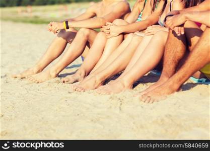 friendship, happiness, summer vacation, holidays and people concept - close up of friends sitting beach