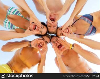 friendship, happiness, summer vacation, holidays and people concept - group of smiling friends wearing swimwear standing in circle and shouting over blue sky