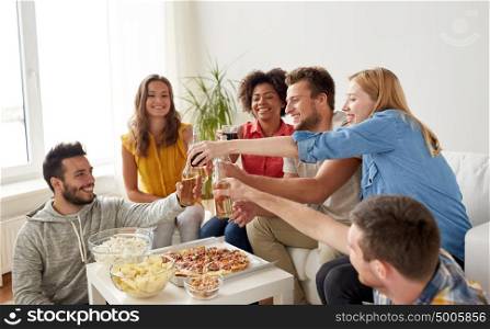 friendship, holidays, fast food and celebration concept - happy friends having party and clinking drinks at home. friends having party and clinking drinks at home