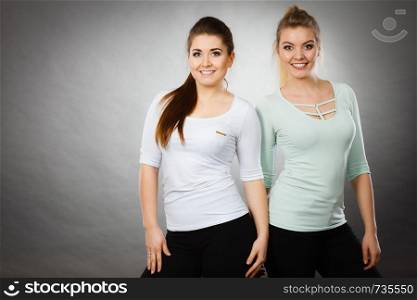 Friendship, human relations concept. Two happy women friends having fun smiling with joy wearing white tops. Two happy women friends having fun