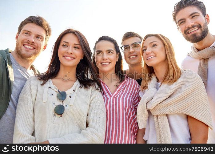 friendship, leisure and people concept - group of happy friends outdoors in summer. group of happy friends outdoors