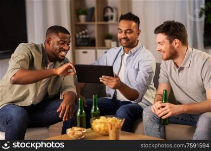 friendship, leisure and people concept - male friends with tablet pc computer drinking beer at home at night. male friends with tablet pc drinking beer at home