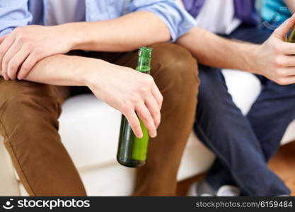 friendship, leisure, people and alcohol concept - close up of male friends drinking beer at home