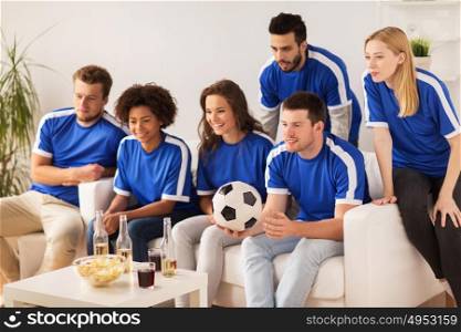 friendship, leisure, sport and entertainment concept - happy friends or football fans with drinks watching soccer at home. friends or football fans watching soccer at home
