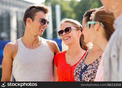 friendship, leisure, summer and people concept - group of smiling friends in city