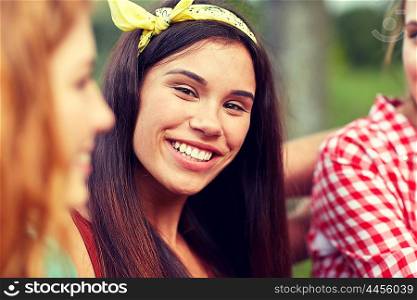 friendship, leisure, summer and people concept - happy young woman with group of friends outdoors