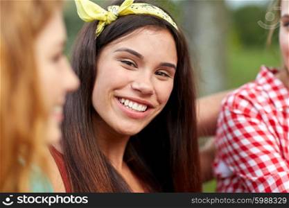 friendship, leisure, summer and people concept - happy young woman with group of friends outdoors