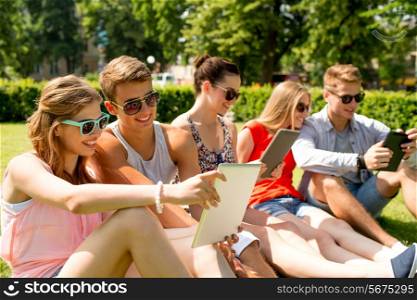 friendship, leisure, summer, technology and people concept - group of smiling friends with tablet pc computers making selfie in park