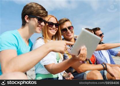 friendship, leisure, summer, technology and people concept - group of smiling friends with tablet pc computer sitting outdoors