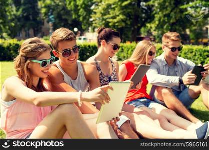 friendship, leisure, summer, technology and people concept - group of smiling friends with tablet pc computers making selfie in park