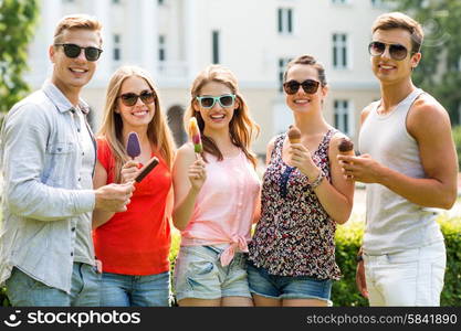 friendship, leisure, sweets, summer and people concept - group of smiling friends with ice cream outdoors