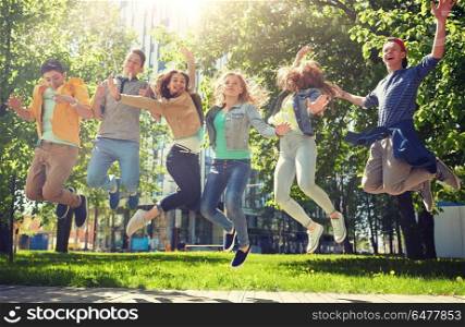 friendship, motion, action, freedom and people concept - group of happy teenage students or friends jumping outdoors. happy teenage students or friends jumping outdoors. happy teenage students or friends jumping outdoors