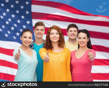 friendship, patriotism and people concept - group of smiling teenagers standing over american flag background