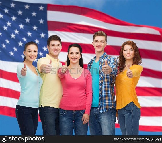 friendship, patriotism and people concept - group of smiling teenagers standing over american flag background