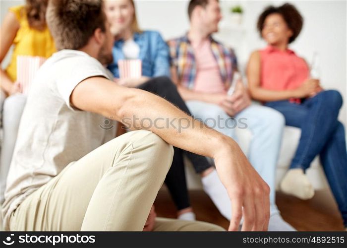 friendship, people and communication concept - close up of man with friends at home