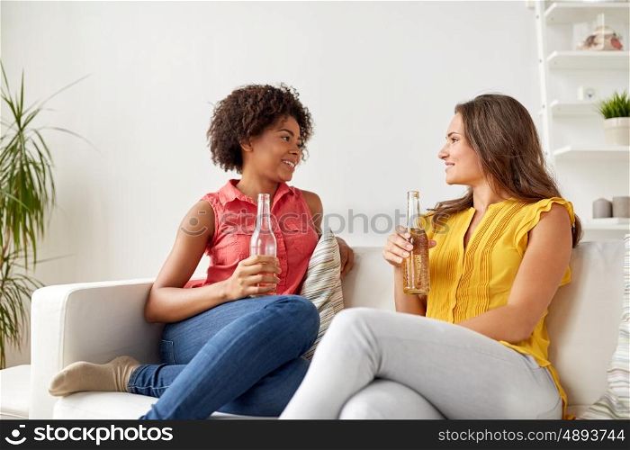friendship, people and communication concept - happy women with beer talking at home