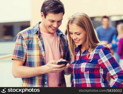 friendship, people, technology and education concept - group of smiling students with smartphone outdoors