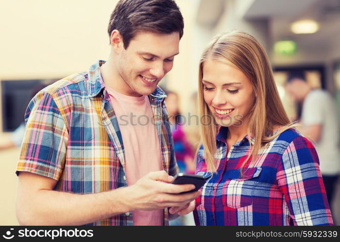 friendship, people, technology and education concept - group of smiling students with smartphone outdoors