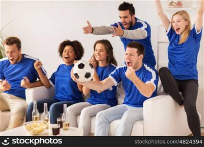 friendship, sport, people and entertainment concept - happy friends or football fans watching soccer and celebrating victory at home