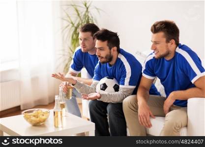 friendship, sport, people and entertainment concept - happy male friends or football fans watching soccer on tv at home