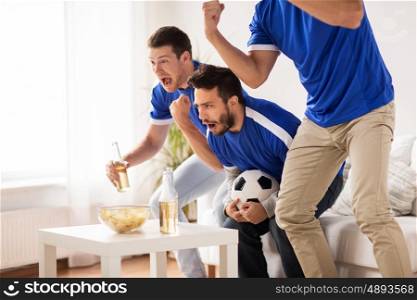 friendship, sport, people and entertainment concept - happy male friends or football fans watching soccer at home