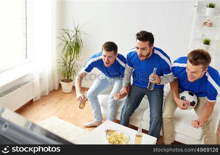 friendship, sport, people and entertainment concept - happy male friends or football fans with beer and chips watching soccer on tv at home. friends or football fans watching soccer at home