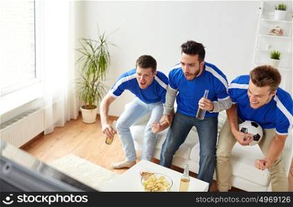 friendship, sport, people and entertainment concept - happy male friends or football fans with beer and chips watching soccer on tv at home. friends or football fans watching soccer at home