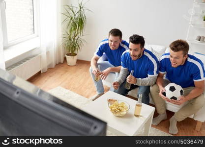 friendship, sport, people and entertainment concept - happy male friends or football fans with beer watching soccer at home. friends or football fans watching soccer at home