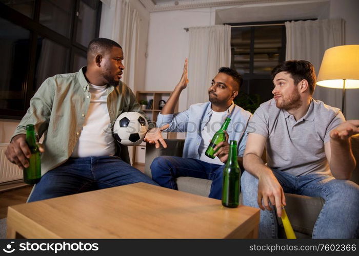 friendship, sports and entertainment concept - disappointed male friends with soccer ball and vuvuzela watching football game at home. sad friends with ball and vuvuzela watching soccer