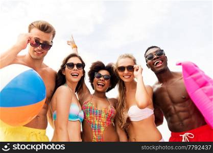 friendship, summer holidays and people concept - group of happy friends in sunglasses on beach. happy friends in sunglasses on summer beach