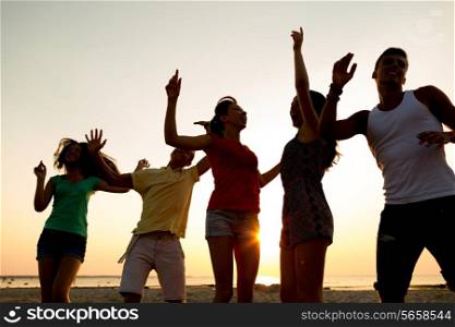 friendship, summer vacation, holidays, party and people concept - group of smiling friends dancing on beach