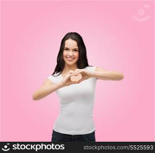friendship, t-shirt design and happy people concept - smiling girl in white blank t-shirts showing heart with hands