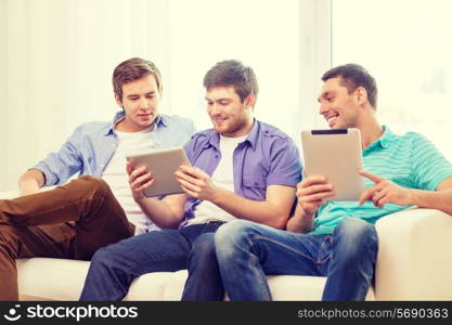 friendship, technology and home concept - smiling male friends with tablet pc computers at home