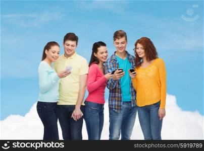 friendship, technology and people concept - group of smiling teenagers with smartphones over blue sky with white cloud background