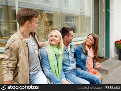 friendship, travel and vacation concept - group of smiling friends in the city
