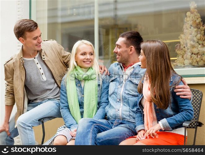 friendship, travel and vacation concept - group of smiling friends in the city
