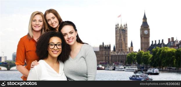 friendship, travel, tourism, diverse and people concept - group of happy different women in casual clothes over london city and big ben tower background