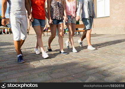 friendship, travel, tourism, summer vacation and people concept - close up of teenage friends walking in city