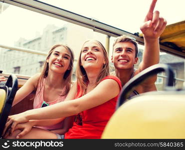 friendship, travel, vacation, summer and people concept - group of smiling friends traveling by tour bus