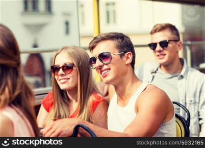 friendship, travel, vacation, summer and people concept - smiling couple traveling by tour bus