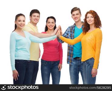 friendship, youth and people concept - group of smiling teenagers making high five
