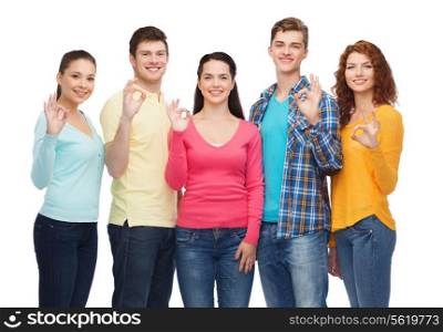 friendship, youth and people concept - group of smiling teenagers showing ok sign