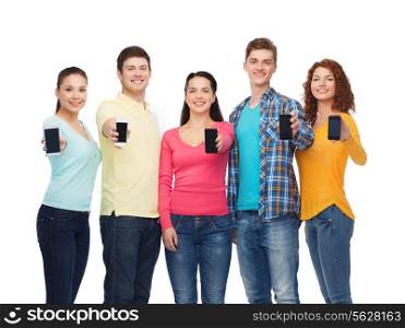 friendship, youth and people concept - group of smiling teenagers with smartphones