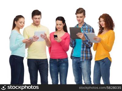 friendship, youth and people concept - group of smiling teenagers with smartphones and tablet pc computers