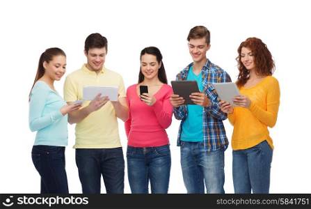 friendship, youth and people concept - group of smiling teenagers with smartphones and tablet pc computers